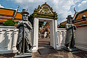 Bangkok Wat Pho, doorway in between the eastern and the western court yard guarded by humorously-depicted Europeans looking guard. 